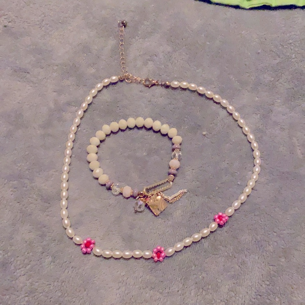The bracelet is a white and pastel and The necklace is pink and white